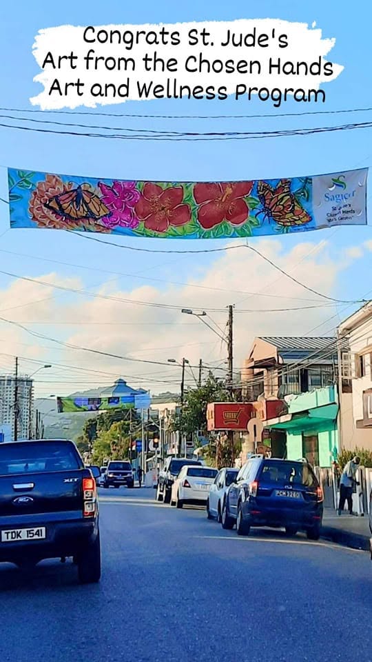 The Congrats St. Jude's street banner featuring Chosen Hands program art in Trinidad
